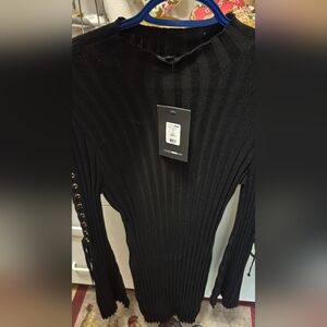 Black Ribbed Dress With Gold Hardwear On Bell Sleeves